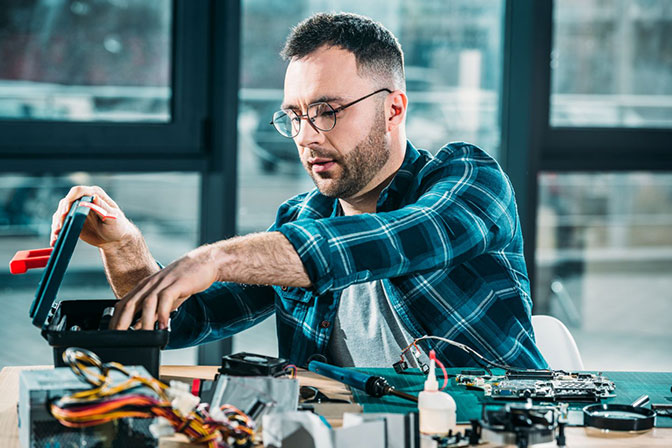 An Phone Fix technician talking to a customer about their tech repair needs